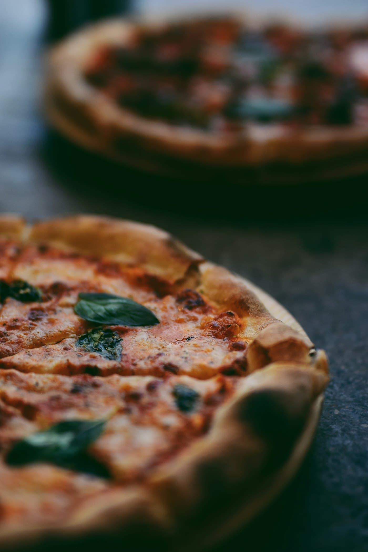 Pizza shop owner reviewing sales data on Reforno